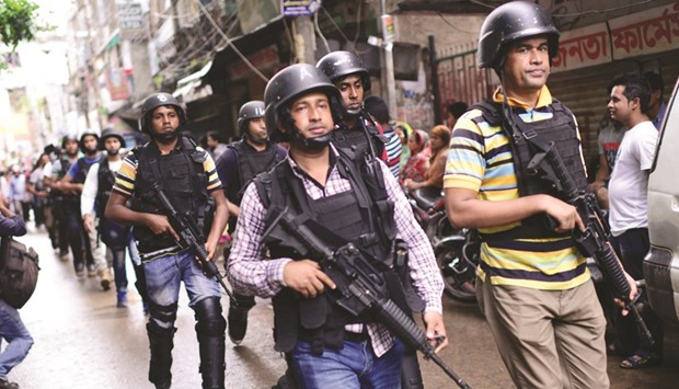 Police patrolling the area near the house where nine suspected Islamist extremists were killed in a gun-battle in Dhaka yesterday.