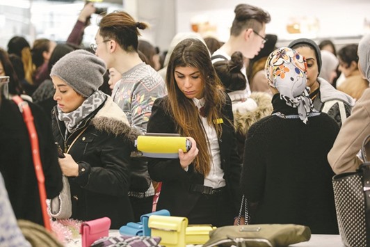 Customers look at handbags on display inside a department store in London. The Confederation of British Industry said Britainu2019s retail sales fell sharply between June 28 and July 14 and retailers cut orders with suppliers by the most since the 2008-09 financial crisis.