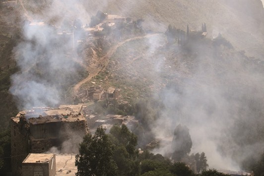 Smoke rises from burning houses in the al-Sarari area after government forces captured it from Iran-allied Houthi militia in Taiz province, Yemen, on Tuesday.