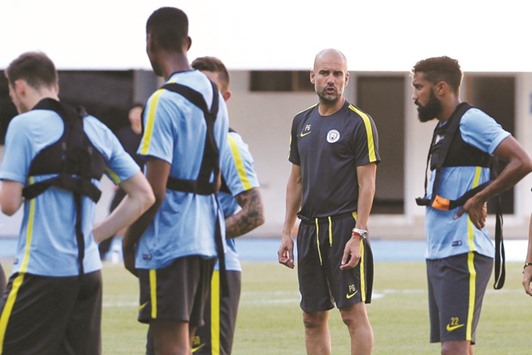 Manchester City team manager Pep Guardiola (2nd R) attends a training session ahead of their International Champions Cup tournament in China.