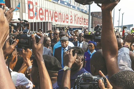 Etienne Tshisekedi, centre, was surrounded by journalists as he arrived in Kinshasa yesterday.