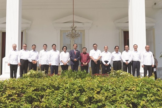 Widodo and Vice-President Jusuf Kalla pose with new members of his cabinet, (from left) Minister of Trade Enggartiasto Lukita, Rural and Transmigration Minister Eko Putro, Security Minister Wiranto, Bureaucratic Reform Minister Asman Abnur, Industry Minister Airlangga Hartanto, Finance Minister Sri Mulyani, Maritime Minister Luhut Binsar Panjaitan, Energy and Mineral Resource Minister Chandra Thahar, Land and Spatial Planning Minister Sofyan Djalil, Transport Minister Budi Karya Sumadi, Investment Co-ordinating Agency Thomas Lembong, and Education and Culture Minister Muhadjir Effendy.