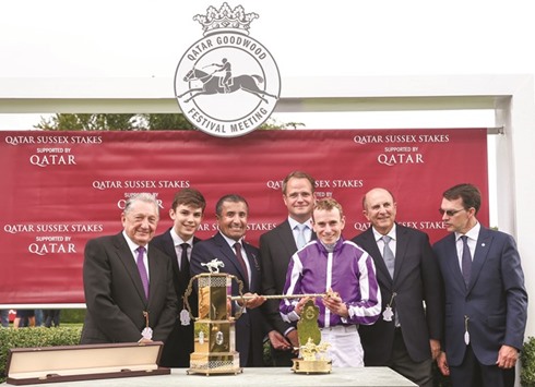 HH Sheikh Mohamed bin Khalifa al-Thani presents Ryan Moore with his trophy after the jockey rode The Gurkha, trained by Aiden Ou2019Brien, to a victory in the Qatar Sussex Stakes (Gr1) on Day Two of the Qatar Goodwood Festival yesterday. PICTURE: Juhaim
