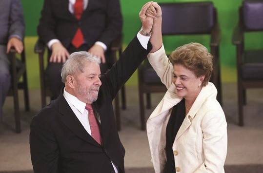Brazilu2019s President Dilma Rousseff (R) greets former president Luiz Inacio Lula da Silva during the appointment of Lula da Silva as chief of staff, at Planalto palace in Brasilia, Brazil, March 17, 2016.