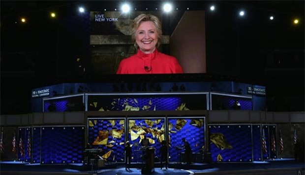 Delegates cheer as a screen displays Democratic presidential candidate Hillary Clinton delivering remarks to the crowd on the second day of the Democratic National Convention at the Wells Fargo Center in Philadelphia on Tuesday.