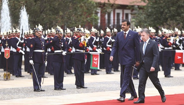 HH the Emir Sheikh Tamim bin Hamad al-Thani, accompanied by President Juan Manuel Santos, reviews a guard of honour at the Presidential Palace in Bogota yesterday.