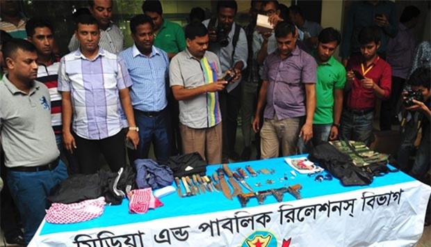 Bangladesh police exhibit guns and knives recovered from the house where police killed nine suspected extremists in Dhaka this week.