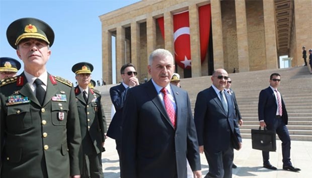 Turkey's Prime Minister Binali Yildirim (second left) and Chief of the General Staff of the Turkish Armed Forces Hulusi Akar (left) are seen during Turkish Supreme Military Council (YAS) members' visit to Anitkabir, mausoleum of Mustafa Kemal Ataturk, in Ankara on Thursday.