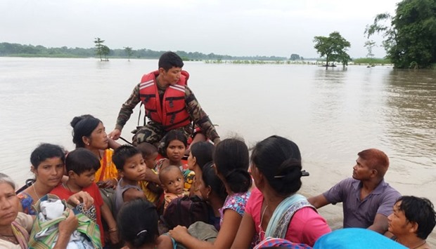 An army officer assists flood victims in Jhapa, Nepal