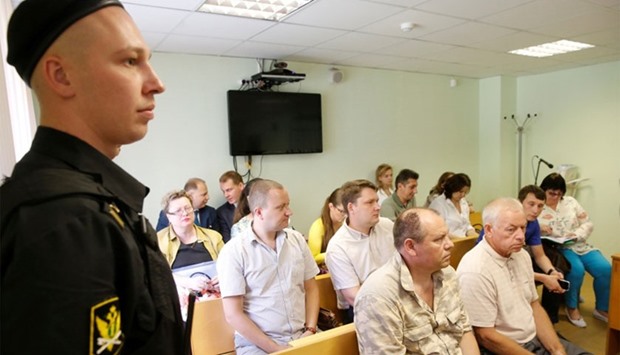 Five suspects, including (L-R, 1st row) employees of Vnukovo airport Vladimir Ledenev, Vladimir Martynenko, (L-R, 2nd row) Roman Dunayev, Aleksandr Kruglov and Nadezhda Arkhipova (L, 3rd row) attend a hearing on the accident, which resulted in the death of Christophe de Margerie, the chief executive of Total company, at the Solntsevo District Court on the suburbs of Moscow, Russia