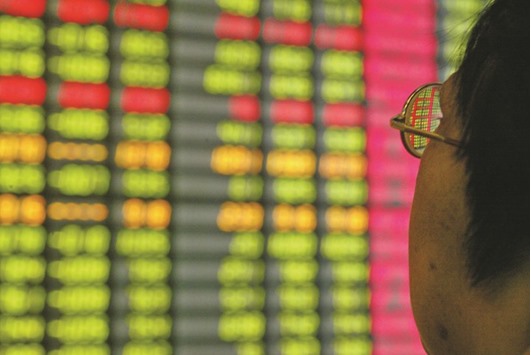 A Chinese investor monitors share prices at a securities company in Beijing. Shanghai Stock Exchange fell 0.6% yesterday after shedding 1.9% on Wednesday.