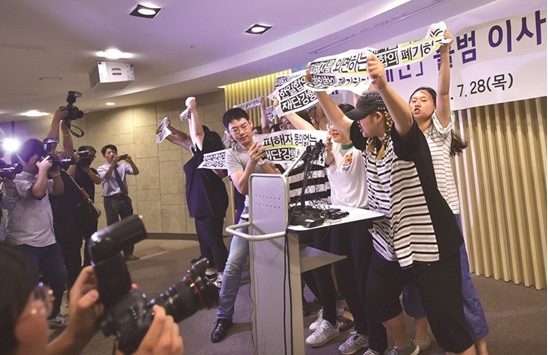 South Korean protesters denounce a deal between Seoul and Tokyo on resolving a long-running row over u201ccomfort womenu201d, before a press conference by officials from the Reconciliation and Healing Foundation in Seoul yesterday.