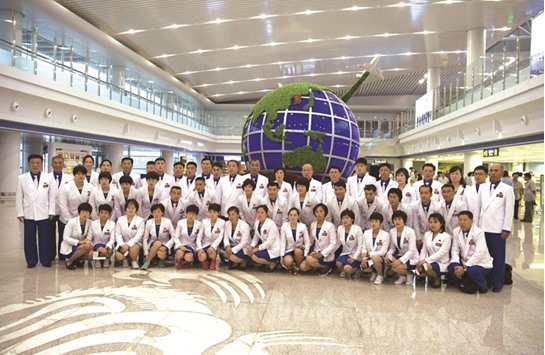 North Koreau2019s delegation for the 2016 Rio Olympic Games pose for a group photo before leaving Pyongyang International Airport to Brazil. (AFP)
