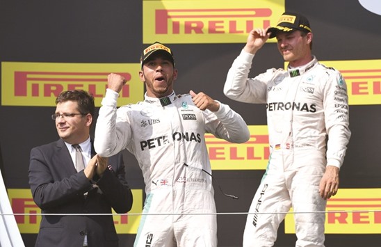 Mercedes driver Lewis Hamilton (left) celebrates his win in Sundayu2019s Hungarian Grand Prix as teammate Nico Rosberg looks on. (AFP)