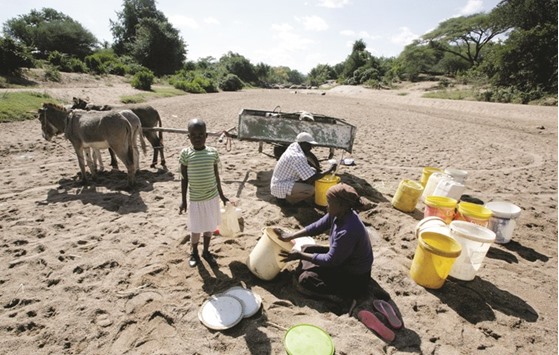 A family tries to glean water from a dry riverbed in drought-hit Masvingo, Zimbabwe.