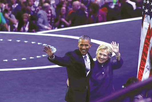 Obama and Clinton wave to the crowd at the Democratic National Convention at the Wells Fargo Centre in Philadelphia late on Wednesday.