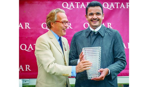 Lord March (left) presents HE Sheikh Joaan bin Hamad al-Thani with the trophy after Al Shaqab Racingu2019s Mehmas won the Qatar Richmond Stakes (Gr2) on third day of the Qatar Goodwood Festival yesterday.