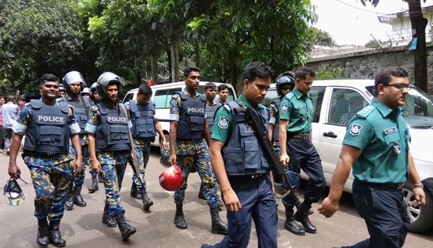 Security personnel are seen near the cafe in Dhaka, which was stormed by militants.