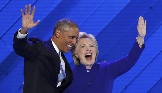President Barack Obama and presidential nominee Hillary Clinton appear on stage together after his speech on the third night at the Democratic National Convention in Philadelphia.