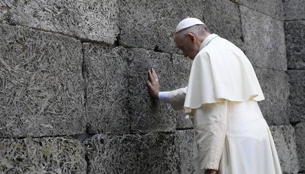 Pope Francis pays respects by the death wall in the former Nazi German concentration and extermination camp Auschwitz-Birkenau in Oswiecim, Poland.