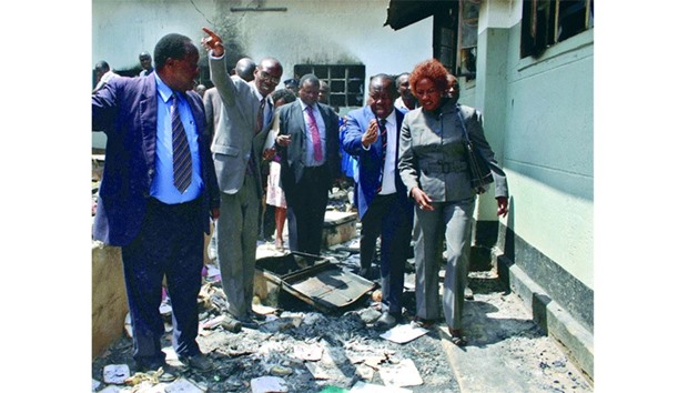 Matiangu2019i (second right) is led by local education officials during an inspection of school buildings destroyed by fire at Itiero boys high school in Kisii county. Dozens of secondary schools across Kenya have been deliberately set on fire, but as the authorities struggle to pinpoint why.