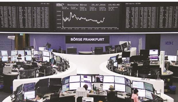 Traders work at the Frankfurt Stock Exchange. The DAX 30 closed up 0.6% to 10,337.50 points yesterday.