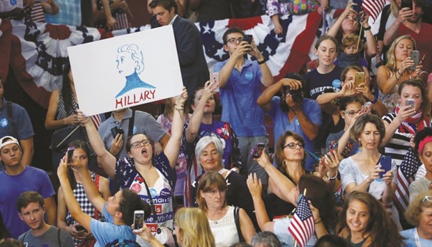 Supporters cheering as Democratic presidential candidate Hillary Clinton campaigns with vice presidential candidate Senator Tim Kaine on the campus of Temple University in Philadelphia, Pennsylvania, yesterday.