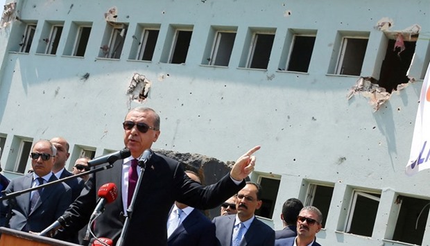 Turkey's President Tayyip Erdogan addresses the audience as he visits the Turkish police special forces base damaged by fighting during a coup attempt in Ankara.