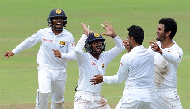 Sri Lanka's celebrates after dismissed Australia's Peter Nevill during the fifth and the final day of their opening Test match between Sri Lanka and Australia at the Pallekele International Cricket Stadium in Pallekele on July 30, 2016.