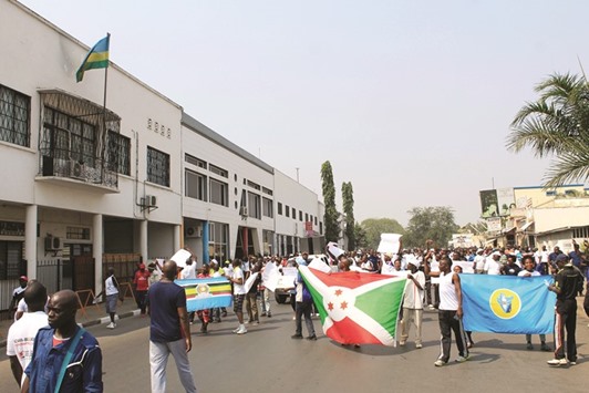 Protesters march past the Rwandan embassy in Bujumbura yesterday in protest against a UN Security Council decision to send a police contingent to the violence-wracked country and accusing Rwanda of training Burundi rebels.