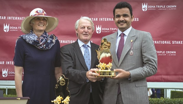 HE Sheikh Joaan bin Hamad al-Thani receives the trophy after Al Shaqab Racingu2019s Al Mourtajez won the Qatar International Stakes (Gr1PA) on the last day of the Qatar Goodwood Festival yesterday.