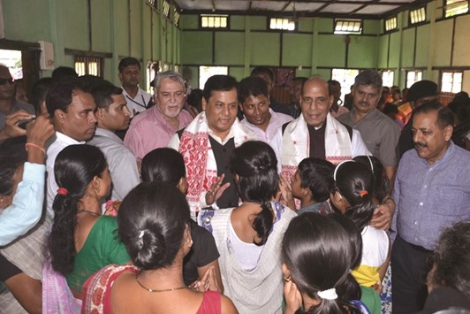 Federal Home Minister Rajnath Singh and Assam Chief Minister Sarbananda Sonowal talk to displaced persons at a flood relief camp at Jagibhaktgaon in Morigaon district of Assam.