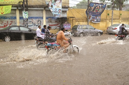 Vehicles move on a road during heavy rain in Lahore. Pakistanu2019s Met office has predicted heavy rains in different parts of the country for the next three days.
