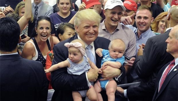 US Republican candidate Donald Trump holds two babies after his Town Hall address at the Gallogly Events Center in Colorado Springs.