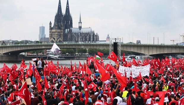 Supporters of Turkish President Recep Tayyip Erdogan attend a rally on July 31, 2016 in Cologne, as tensions over Turkey's failed coup put authorities on edge. Up to 30,000 people are expected to answer a call to take to the streets issued by a pro-Erdogan group, the Union of European-Turkish Democrats (UETD), according to police.