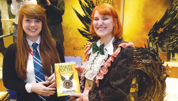Harry Potter fan Fran Plagge poses for photographs after becoming the first person to receive the new Harry Potter script book inside Waterstones bookshop on Piccadilly yesterday morning after a midnight party celebrating the publication of Harry Potter and the Cursed Child Parts One & Two script book.