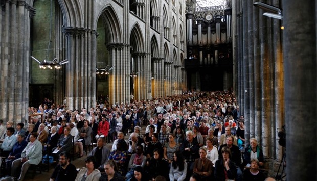People attend a Mass in tribute to priest Jacques Hamel in the Rouen Cathedral. Muslims across France were invited to participate in Catholic ceremonies today to mourn a priest whose murder by jihadist teenagers sparked fears of religious tension.