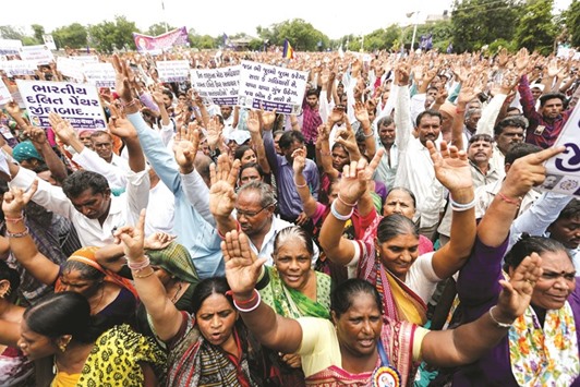 People shout slogans as they attend a protest rally in Ahmedabad against what they say are attacks on the Dalit community.