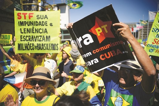 Hundreds of people hold a protest against suspended President Dilma Rousseff outside the National Congress in Brasilia yesterday. Protesters took to the streets yesterday to demand the final leaving of Rousseff or for her to defend her permanence, just five days before the start of the Rio 2016 Olympic Games.