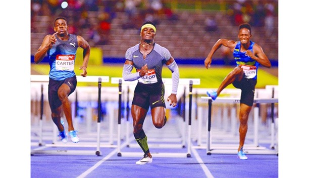 Omar McLeod  (C) finishes first at 13.01 seconds ahead of Deuce Carter (L) and Tyler Mason (R) during the National Senior Championships at National Stadium in Kingston on Saturday.