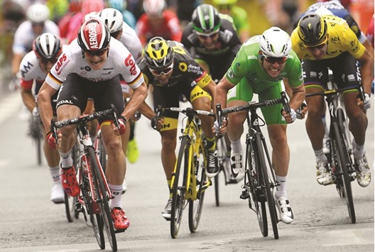 Great Britainu2019s Mark Cavendish (second right) crosses the finish line ahead of Germanyu2019s Andre Greipel (left), Franceu2019s Bryan Coquard (second left) and Slovakiau2019s Peter Sagan (right) at the end of the 223,5km third stage of the 103rd edition of the Tour de France cycling race between Granville and Angers, France, yesterday. (AFP)