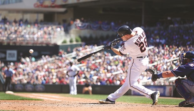 Minnesota Twins right fielder Max Kepler (26) hits an RBI single during the fifth inning on Sunday at Target Field in Minneapolis.