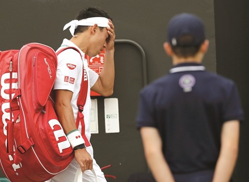 Japanu2019s Kei Nishikori walks off the court after retiring due to injury from his match against Croatiau2019s Marin Cilic yesterday. (Reuters)