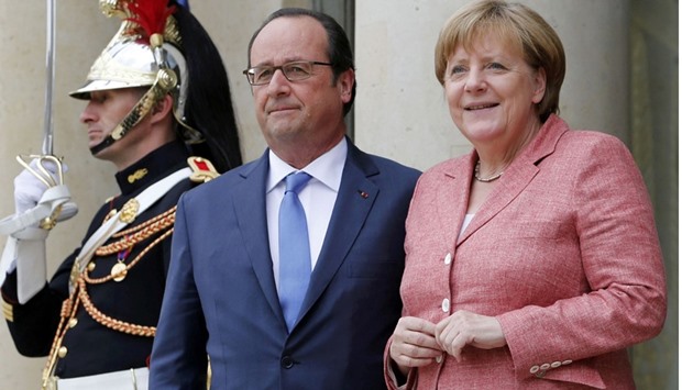 French President Francois Hollande welcomes German Chancellor Angela Merkel as she arrives to attend a Western Balkans summit at the Elysee palace in Paris.