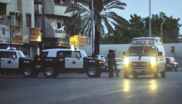 Saudi policemen standing guard at the site where a suicide bomber blew himself up in the early hours of yesterday near the American consulate in Jeddah.