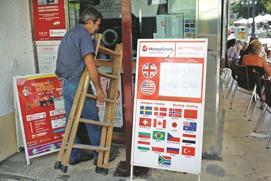 A money changing shop displays the exchange rates of the pound and the US dollar against the euro in Fuengirola, Spain. The pound touched a 31-year low of $1.3115 yesterday.