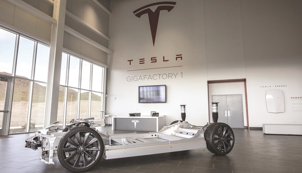 Tesla Motors logo is displayed in the lobby of the companyu2019s Gigafactory in McCarran, Nevada, the US. Teslau2019s goal of shaking up the automobile industry has hit a fresh speed bump as disappointing car production suggests a longer wait before it reaches profitability.