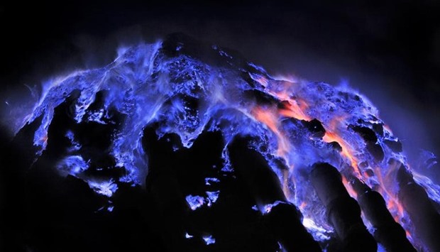 Blue flames light up the night sky above Kawah Ijen volcano