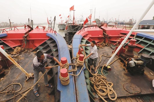 Fishermen reinforce their fishing boats yesterday to withstand strong winds as typhoon Nepartak is forecast to hit in the coming days, at a port in Lianyungang, in eastern Chinau2019s Jiangsu province.