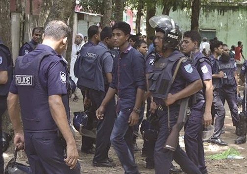 Police detain a suspected militant following an attack near Bangladeshu2019s largest Eid prayer rally in Kishoreganj, some 130km from Dhaka yesterday.